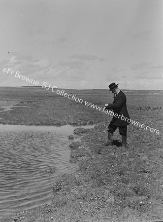 FR.P.G.KENNEDY S.J. PHOTOGRAPHING RED-NECKED PHALAROPE